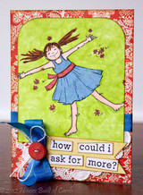 Sample card: the girl in a blue dress on lime green with a red floral border, a blue bow, a red button and 'how could i ask for more?' word strips