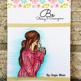 Card with Angie Blom's girl in a pink knit sweater holding coffee, 'Be Strong & Courageous.'
