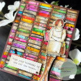 Wakely Girl colored in warm neutrals standing beside a rainbow shelf of washi tape rolls, with a birthday greeting on a torn strip.