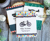 Trio of white cards with triangle-print borders, each stamped with the plane, car or bicycle and a birthday sentiment.