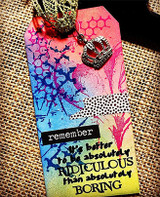 Mixed media tag blended in pink, blue and yellow ink with the star splatter and chicken wire stamped over it, a 'remember' label and the 'It's better to be absolutely ridiculous than absolutely boring' sentiment across the lower half, topped with a gold crown charm.