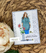 Card with the woman in a teal top and flowers in a vase above a 'gratitude' banner.