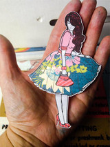 Addison Girl mixed-media card, the AngieGirl figure's skirt colored with patterned papers, 'Let's Party' sentiment on a layered background.