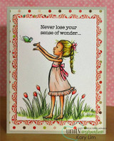 Card with a red and pink patterned border, the girl in a blush dress reaching up to a butterfly over tall grass and tulips, stamped 'Never lose your sense of wonder...'