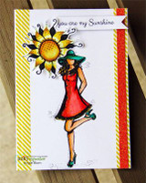 Mila girl in a red dress and teal hat beside a yellow sunflower on a striped card with 'you are my Sunshine'