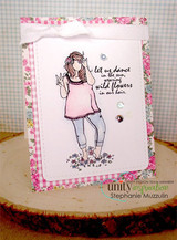 Card with Gianna Girl colored in soft pink on a pale pink panel, the 'let us dance in the sun' sentiment beside her, framed in floral paper with a white bow and clear gems.