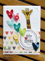 Card with the giraffe surrounded by colorful heart embellishments, 'you make me feel loved all over.'
