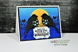 Card with two bird silhouettes on a branch against a gold moon and blue night sky, with 'Just you, doing you, makes you beautiful' on a label.