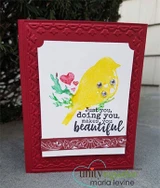 Card with the bird watercolored yellow with gems, pink hearts and green leaves, and 'Just you, doing you, makes you beautiful' on a red embossed base.