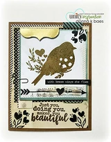 Card with the bird heat embossed in gold on a layered panel with black hearts, an arrow and 'Just you, doing you, makes you beautiful'.