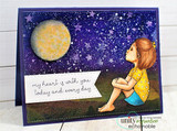 The sitting girl in a yellow top gazing at a glowing moon on a navy starry card with 'my heart is with you today and every day.'