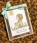 The sitting girl on a soft patterned card tied with a mint bow.