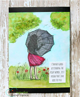 Watercolored card with green trees and a blue sky, the girl in a pink skirt under her umbrella in a poppy meadow, with the here for you sentiment on a small white panel.