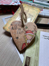 Wooden heart ornament stamped with the little reindeer girl and 'Ally 2023.'