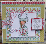 Layered card with the reindeer-antler girl in a patterned coat on green and red holiday papers.