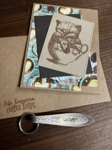 Kitten in a kraft-mounted teacup image with 'life happens, coffee helps.'
