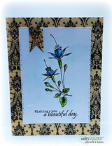 A single fuchsia bloom colored blue-violet on a soft blue panel framed with black damask, captioned "Wishing you a beautiful day."