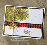 Card with a golden pine bough and a red buffalo-plaid strip and "Winter blessings"
