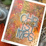 Card with a mixed-media background and a die-cut "CHRISTMAS"