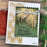Card with a golden pine bough on snowflake paper tied with twine and "Wishing you a blessed Winter"