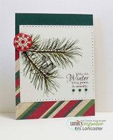 White card with stamped pine boughs and a "Winter bring peace" sentiment and a red snowflake button
