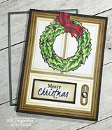 Gold and cream layered card with the wreath coloured green with a red bow inside a gold frame, sentiment 'Merry Christmas' on a kraft strip.