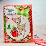 Dashing Deer Delivery, October 2026 Uniquely Unity sample card: the fawn and gift in a pink stitched circle on red and green plaid, with Christmas cheer delivered with love