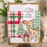 Dashing Deer Delivery, October 2026 Uniquely Unity sample card: the fawn on green plaid beside a small Christmas tree with a Merry Christmas tag