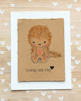 Kraft card of the porcupine on white with scattered hearts, 'Somebody needs a hug.'