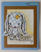 Handmade card featuring the floppy-eared Cuddlebug bunny sitting sweetly, layered on kraft with a star, stamped with 'Hoppy Birthday'.