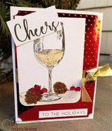 Card with a glass of white wine and pinecones on red polka dots and 'Cheers to the holidays.'