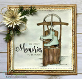 Elegant card in a gold ornate frame with a cream flower and greenery, showcasing the sled and mint-green skates on a soft green watercolor wash.