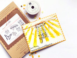A yellow-sunburst card reading "No matter how dark the night, the sun will always rise again.", shown with the red rubber stamp set and ribbon.