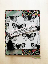 Card with butterflies and a stamped bloom over floral paper, 'beautiful birthday wishes to a beautiful birthday girl.'