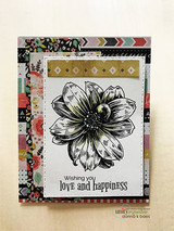 Card with a black-and-white bloom over patterned paper, 'Wishing you love and happiness.'