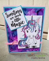 Card with the baby unicorn colored with a pink-and-teal mane on a purple background, stamped 'Sometimes we need a little magic.'