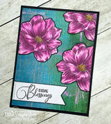 Card with pink magnolias on a black frame over teal wood-grain, 'Sending Blessings.'