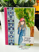 Bright card of the planner girl in a red cap and denim coat holding her camera under a leafy tree, 'every picture tells a story' banner below.
