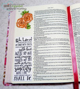 Bible-journaling page with the gardenia border in warm tones beside a ribbon marker.