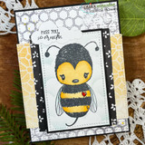 Handmade card featuring the cheery Cuddlebug bumblebee, on a sunny blue sky, stamped with 'Bee positive'.