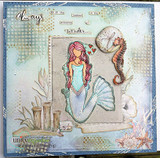 Grungy mixed-media card with a seahorse and shell: the mermaid in muted teal framed on a stamped panel with the presence-of-wonder sentiment.