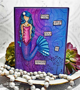 Deep purple and blue embossed card: the mermaid with teal hair and a blue tail beside word tiles reading “hope your day is special.”