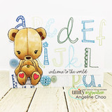 Card with a pastel alphabet background, a patched teddy bear holding a smaller bear coloured in warm tan, buttons and hearts, sentiment 'welcome to the world'.