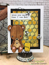 Card in a black frame with a honeycomb-print panel, the teddy bear coloured in brown holding a honey pot, sentiment 'miss you more than I can bear'.