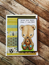 Card on weathered wood with green and yellow patterned strips, the teddy bear coloured in warm brown, sentiment 'miss you more than I can bear'.