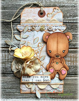 Rustic tag with a pale floral panel and cream blooms, the teddy bear coloured in tan holding a pink heart, sentiment 'miss you more than I can bear'.