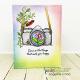 Card with the floral camera over a soft rainbow-sky background and the 'make you happy' sentiment.