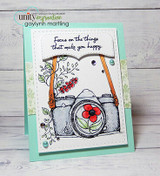 Card with the camera in gray and a red bloom on mint layers and 'Focus on the things that make you happy.'