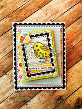 Card on wood grain with nested black scalloped frames around a yellow bird and 'sending a happy hello.'