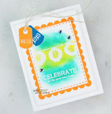 White card with an orange scalloped frame, blended green and blue center and a small tag, lettered 'CELEBRATE let the good times begin.'